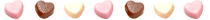 seven white, pink, and brown heart shaped sweets lined up.